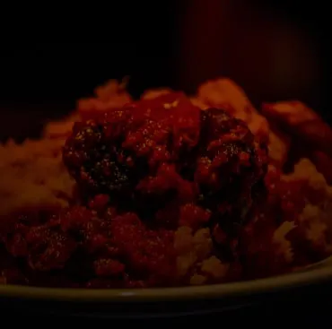 Stewed meat in red pepper sauce over rice