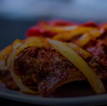 Peppered meat with sliced onions and peppers