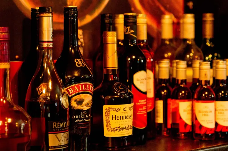Cognac, liqueur and wine bottles on the bar shelves