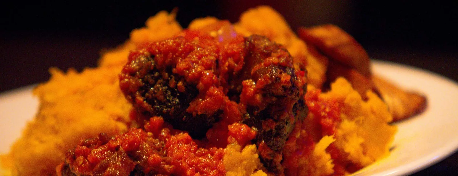 Asaro (yam pottage) with stewed meat and fried plantain