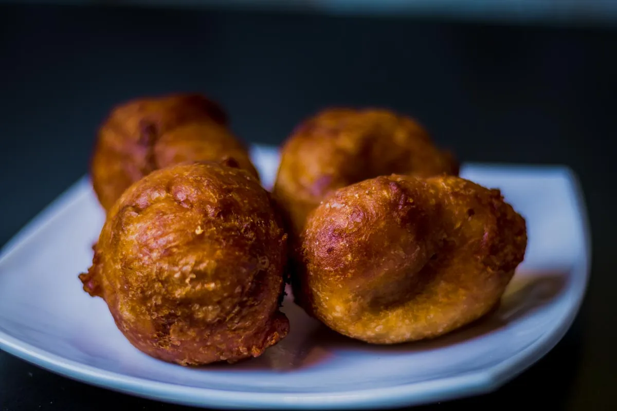 Fried dough balls on a white plate